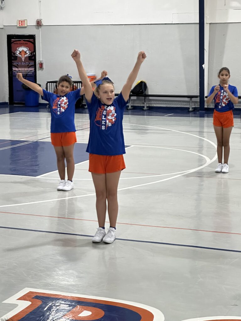 Bethany Christian School elementary cheerleading students performing in the gymnasium.