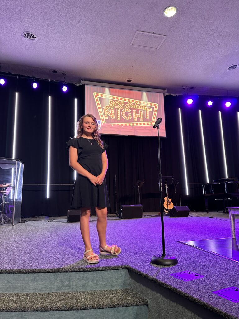 Bethany Christian School middle school student performing at talent night on stage.