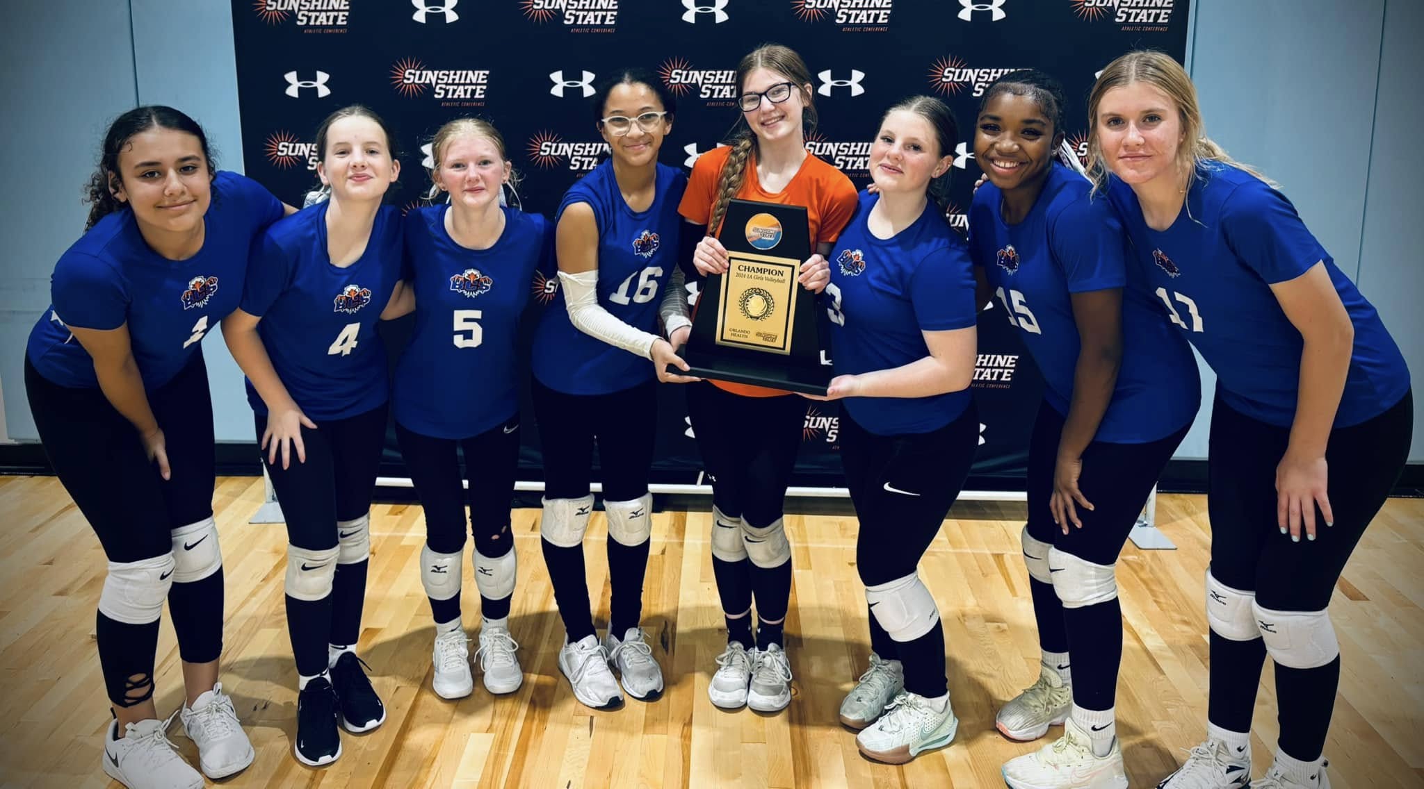 BCS Girls Volleyball Team - Sunshine State Champions Bethany Christian School girls volleyball team celebrating championship win at Sunshine State tournament, holding first place plaque and smiling