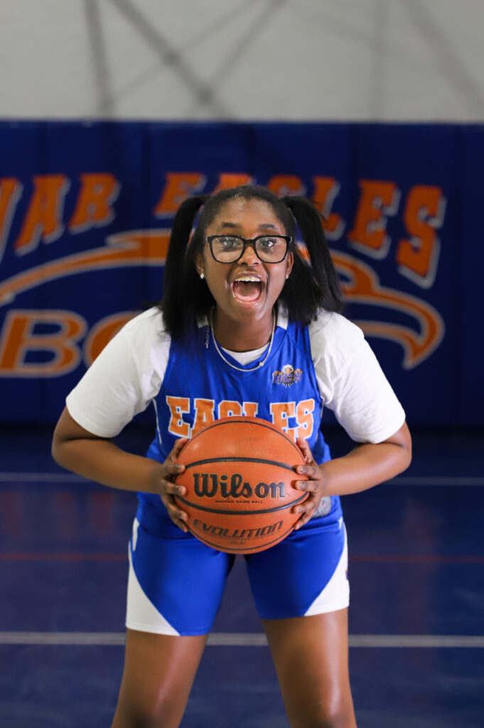 Bethany Christian School middle school basketball athlete showing school spirit in the gym.
