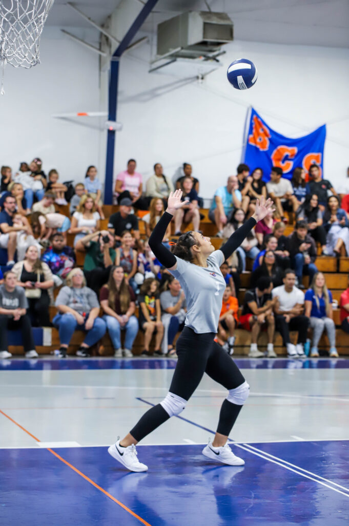 BCS Varsity Volleyball Game with Student Serving