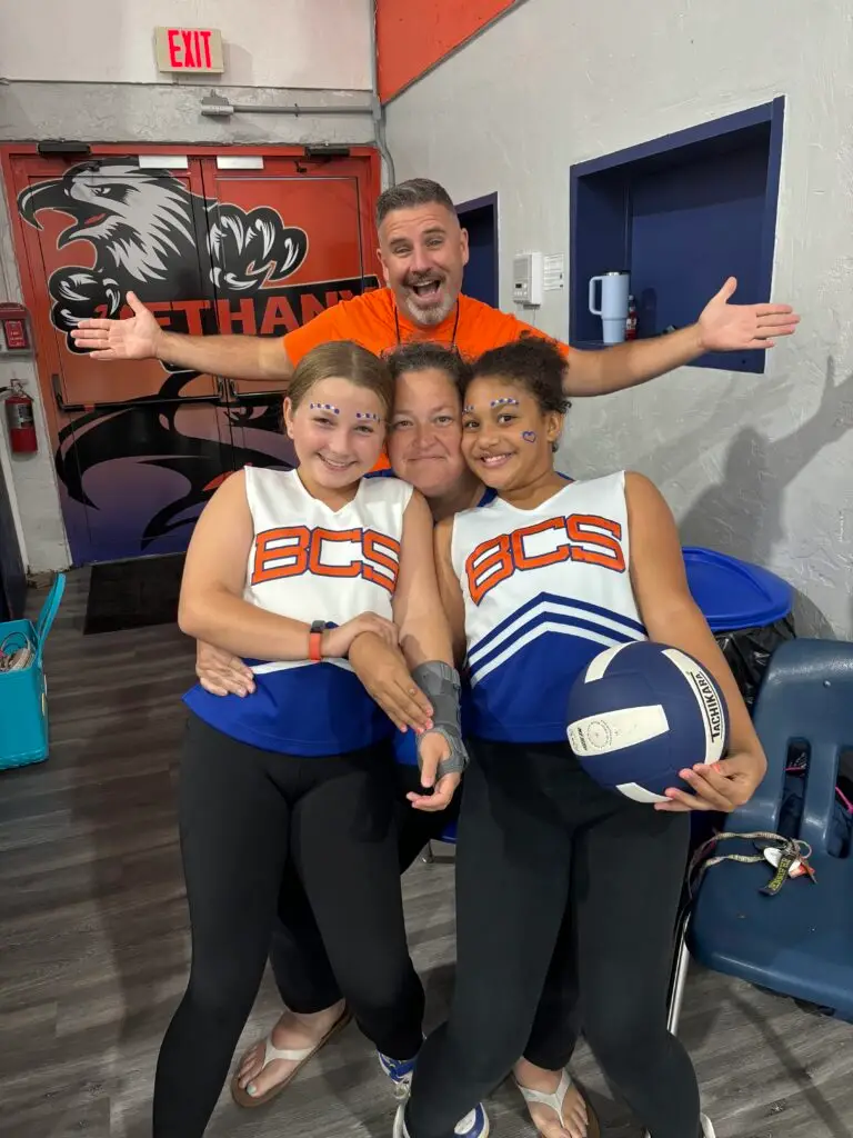 Bethany Christian School elementary cheerleaders posing with coaches and family members.