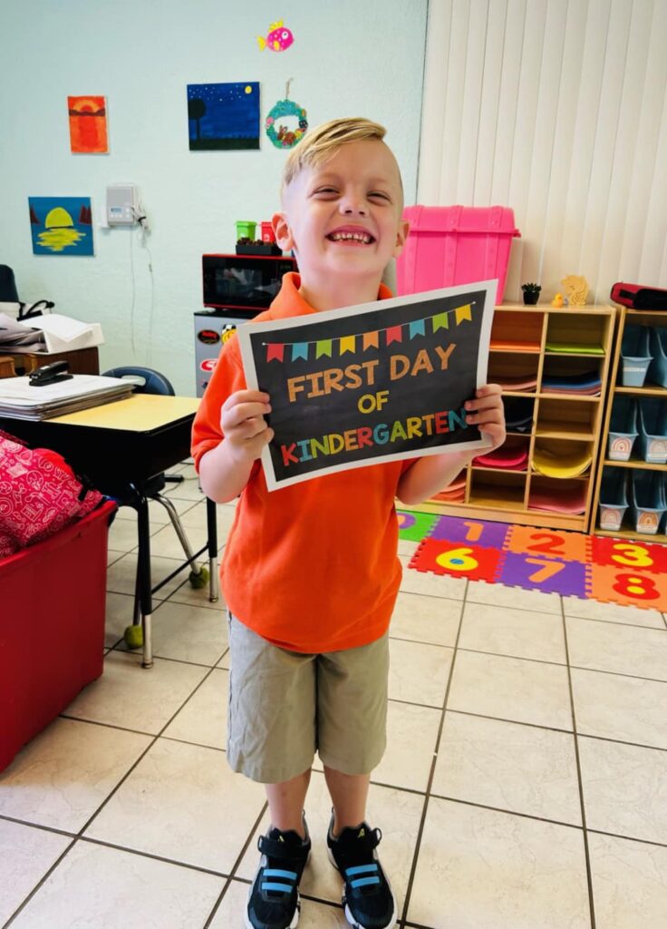 Kindergarten student at Bethany Christian School smiling on the first day of school.