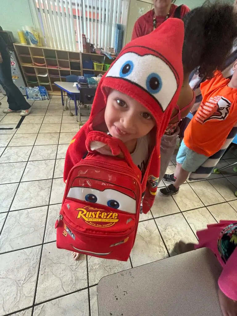 Bethany Christian School student wearing a Lightning McQueen backpack on theme day.