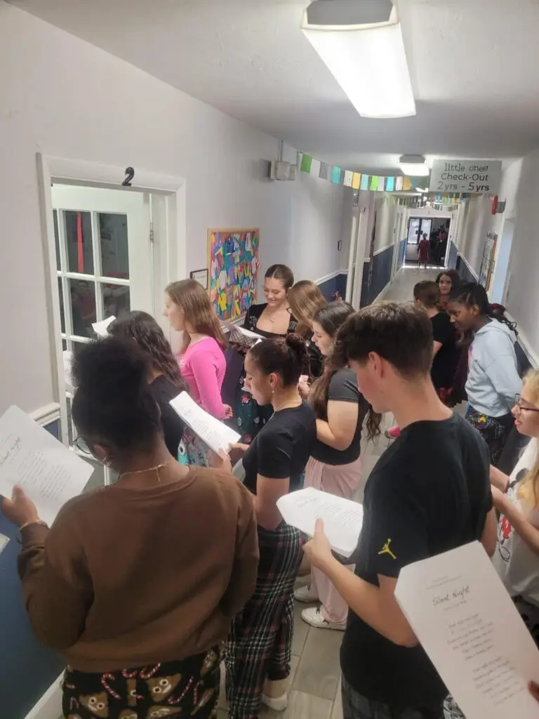 Bethany Christian School high school students singing Christmas carols in the hallway.