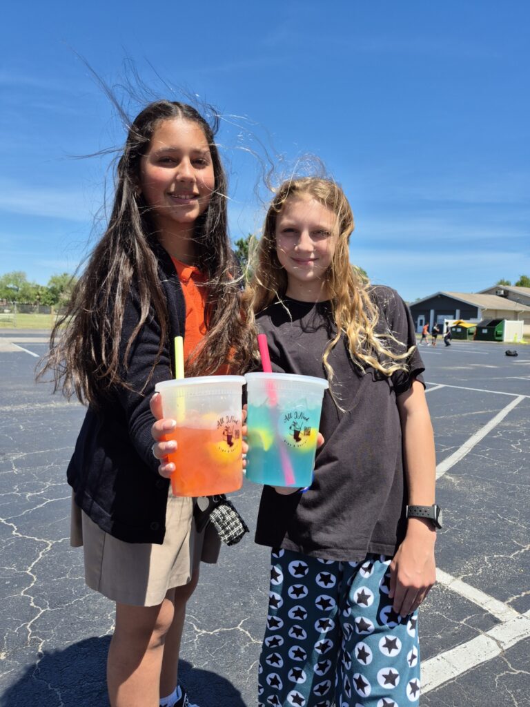Bethany Christian School middle school girls enjoying lemonade together during Field Day festivities on campus