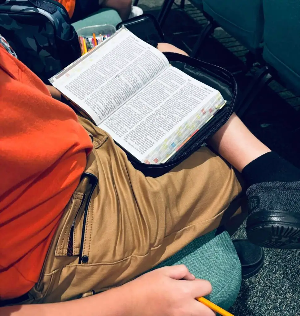 High school student at Bethany Christian School reading and studying the Bible during chapel, deepening personal faith through spiritual formation.