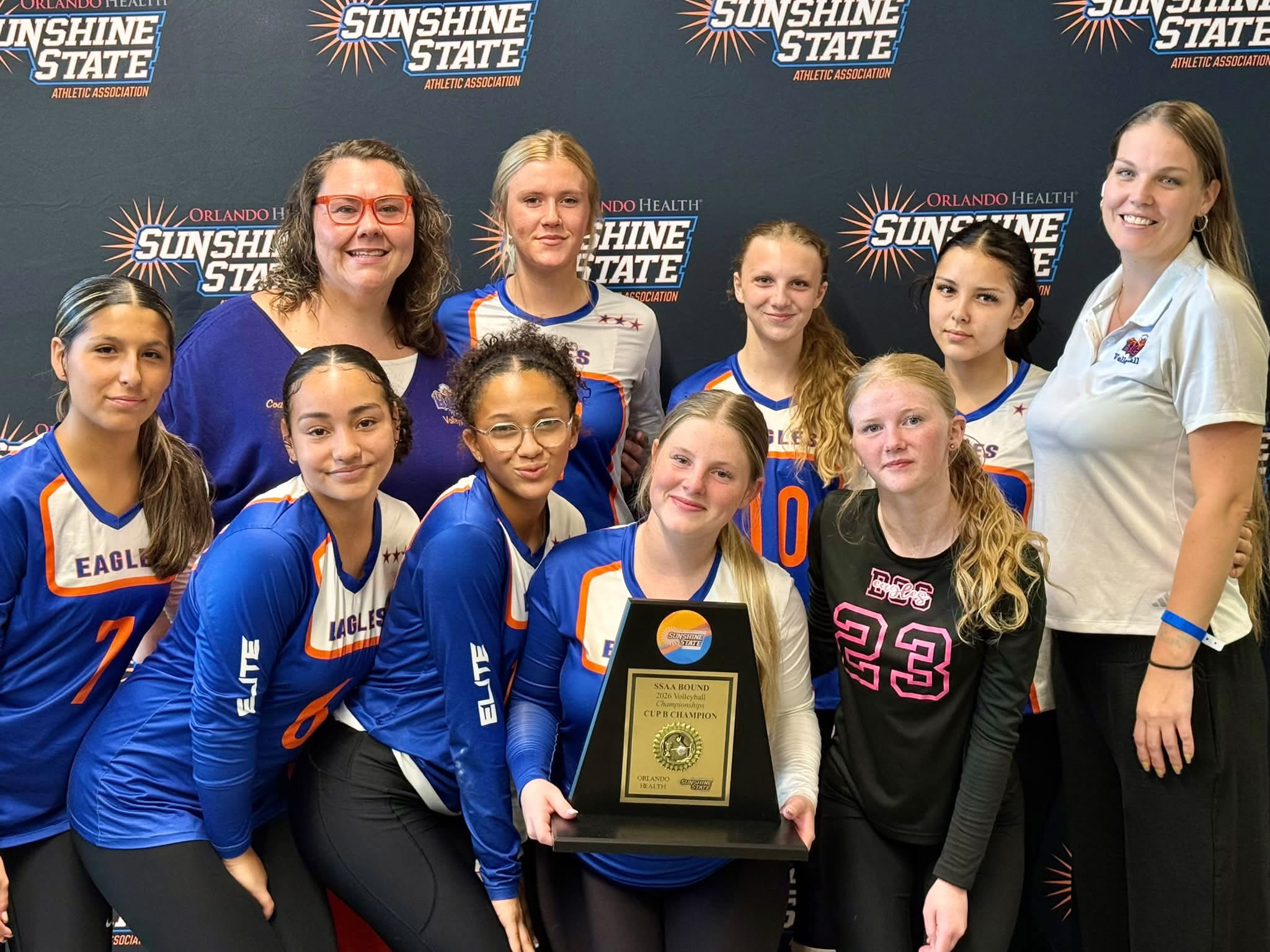 Bethany Christian School girls volleyball team celebrating championship win at Sunshine State tournament, holding first place plaque and smiling